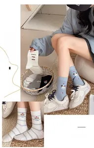 Close-up of cute cartoon dog embroidery on soft cotton mid-calf socks for women