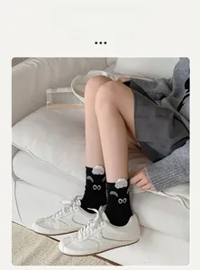 Detail of cute 3D sheep pattern with flocking texture on black cotton mid-calf socks