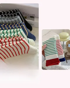 Detailed close-up of striped cotton knit crew socks with various color contrast patterns