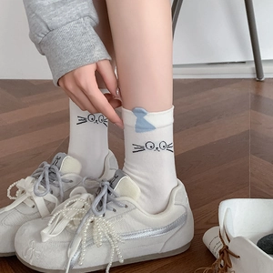 White crew socks with cute black cat face patterns and blue 3D ears for casual wear