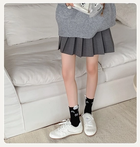 Detail of cute 3D sheep ears on black crew socks with white fleece sheep facial features