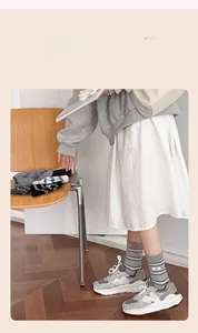 Detail view of gray striped cotton mid-calf socks styled with trendy casual sneakers