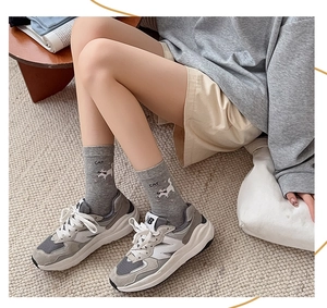 Close-up of gray cotton mid-calf socks with cute cartoon cat print and CAT lettering