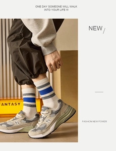 Close-up of retro gray mesh sneakers with classic blue striped crew socks for men