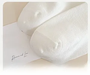 Detailed close-up of reinforced seamless toe stitching on white cotton ballet style socks