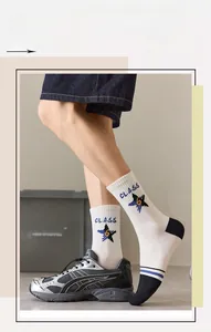 Detail of white cotton athletic crew socks with blue star logo and Class graphic