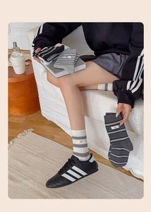 Close-up of striped cotton crew socks with egg label detail and ribbed elastic cuffs