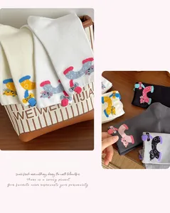 Detail view of 3D cartoon cat embroidery on premium cotton socks in various colors