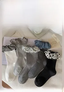 Detail of five-color cotton knit ruffle socks with plaid and heart patterns on edges