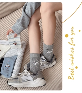 Close-up of cute cartoon cat cotton socks with ribbed cuffs in grey and blue colors