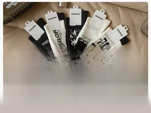 Detailed view of 5 pairs of black and white ribbed cotton mid-calf sports socks set