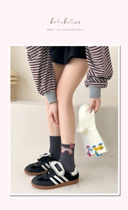 Detail of cute 3D cartoon cat embroidery on grey and beige combed cotton crew socks