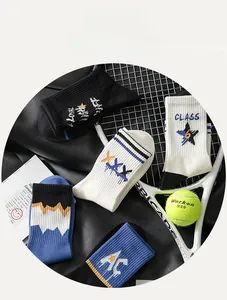Flat lay of cotton crew socks with stars and stripes patterns and tennis props