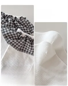 Detail view of reinforced 3D heel and elastic ribbed cuff on checkered frill socks