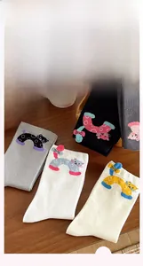Flat lay of colorful combed cotton crew socks featuring cute cartoon cat jacquard patterns