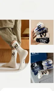 Detail of cotton crew socks with ribbed cuffs and street style letter embroidery