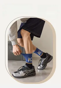Detailed macro view of athletic crew socks featuring blue knit and yellow stripe details