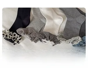 Detailed view of ruffled floral and plaid lace cuffs on ribbed cotton crew socks