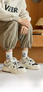 Detail of white cotton crew socks with blue smiley face and I LOVE SKATE text design