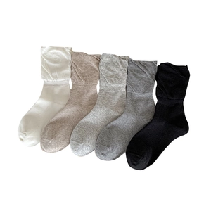 Five pairs of ballet-style ruffled crew socks in minimalist white, beige, and grey shades
