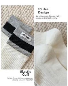 Detail of grey crew socks featuring elastic ribbed cuffs and 3D molded heel design