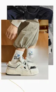 Detail of white mid-calf socks with blue I LOVE SKATE text and smiley face pattern