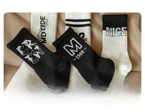 Detailed view of knitted cotton crew socks with ribbed cuffs and street style lettering