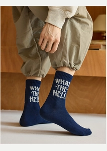 Detail of dark blue crew sock with white WHAT THE HELL lettering on the ankle