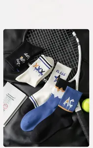 Detail of athletic mid-calf socks with striped ribbing and star patterns on leather backdrop