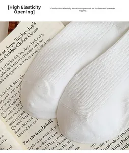Close-up of high-elastic ribbed white cotton socks with non-slip cuff detail