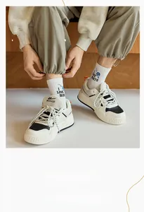 Close-up of retro black and white low-top sneakers with patterned athletic crew socks