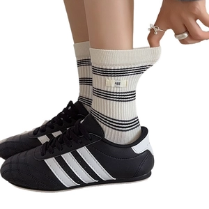 Women's cream and black striped crew socks with 'egg' woven tag and ribbed texture