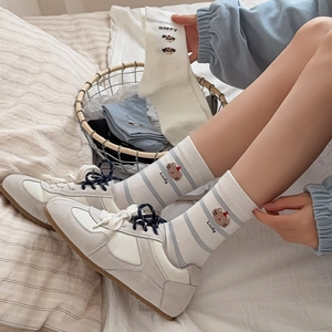 Cute cotton socks with animal embroidery like dog and bear, shown in a cozy home setting