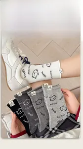 Detail of cute cat cotton crew socks in grey, white, and black with cat labels