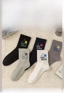Flat lay of five color crew socks with I Love Skate embroidery and smiley faces