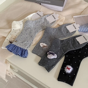 Polka dot crew socks with bow and lace details in neutral grey and cream tones