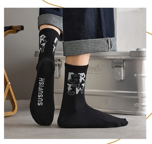 Macro detail of men's crew socks with letter patterns and reinforced ribbed cuffs