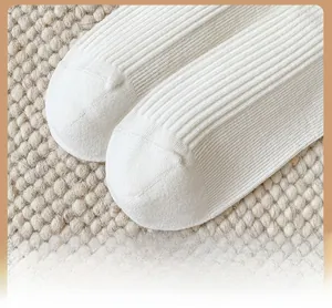 Detail of reinforced toe on white ribbed cotton socks for durability and comfort
