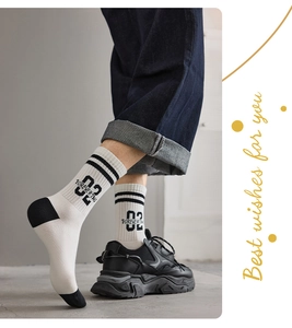 Detail of retro crew sports socks featuring letter print and stylish black-white contrast