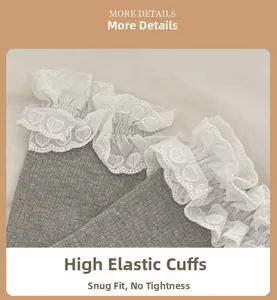 Detail view of grey rib-knit socks featuring white double-layered heart pattern lace trim