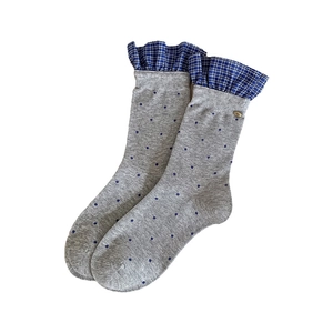 Grey crew socks featuring blue polka dots and plaid ruffle cuffs with a gold charm