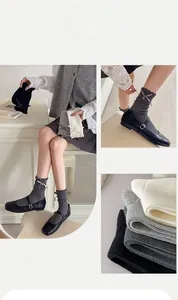 Detail of ruffled knit mid-calf socks featuring ribbon bows and vertical ribbing texture