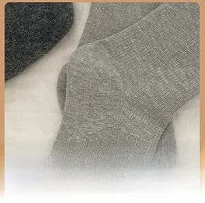 Macro shot of grey ribbed knit cotton sock heel with reinforced stitching detail