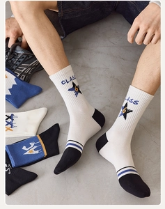 Detail of white cotton athletic crew socks with CLASS embroidery and star pattern logo