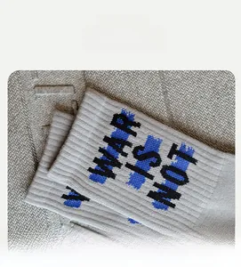 Close-up of ribbed knit cotton crew socks with graffiti letters and elastic cuff