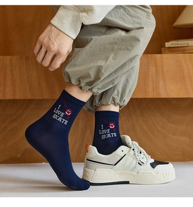 Detail of navy mid-calf cotton socks with 'I LOVE SKATE' text and smile embroidery