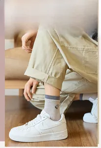 Detail of men's ribbed cotton mid-tube socks with contrast color and side embroidery