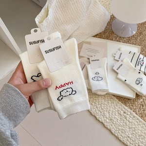 Cute mid-calf white cotton socks featuring cartoon dog patterns and artistic lettering