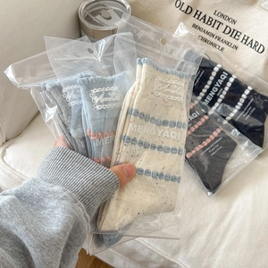 Knitted crew socks with lace embroidery and wavy edges in multiple soft colors