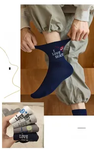 Detailed view of mid-tube socks with embroidered smile and 'I LOVE SKATE' letters